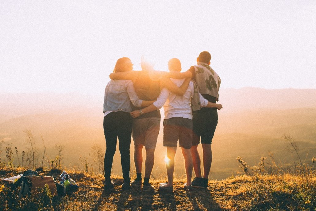 Four Friends Hugging On a Mountain